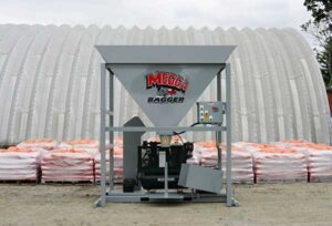An outdoor setup featuring an automatic sandbag filler.