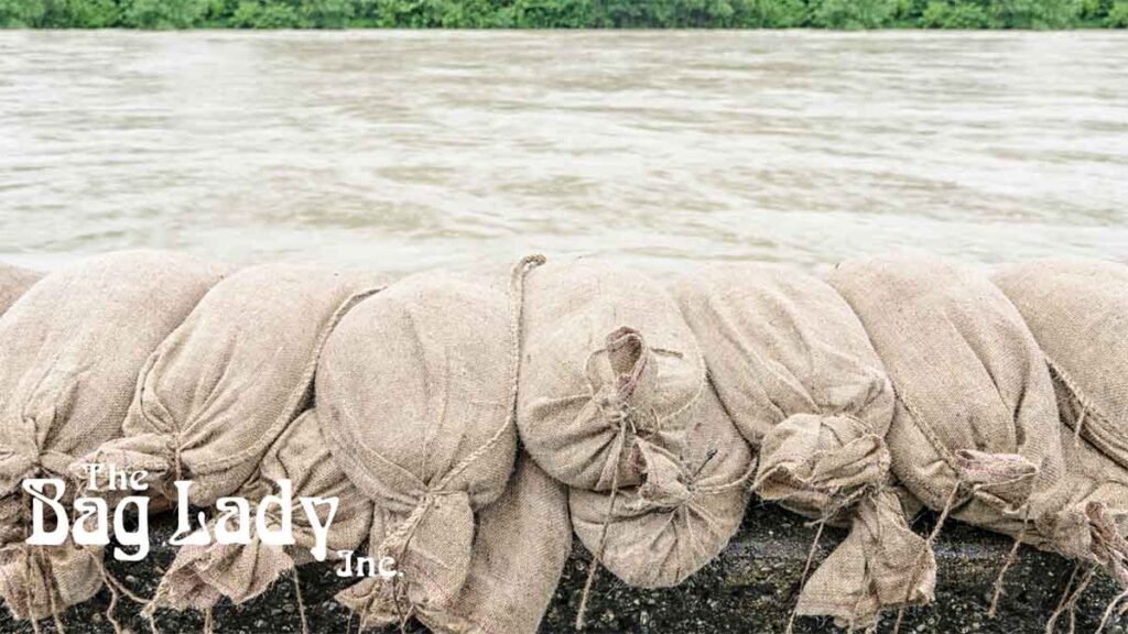 Pile of sandbags placed as a barrier in a flooded outdoor area