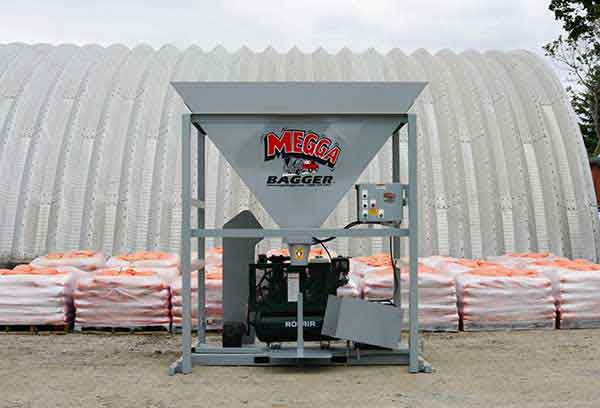  The Bag Lady’s Megga Bagger surrounded by filled sandbags in an outdoor setup