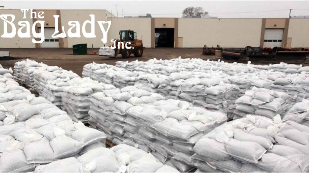 A large stack of sandbags piled outdoors