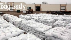 A large stack of sandbags piled outdoors